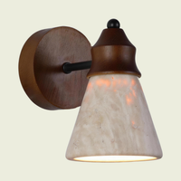 Travertine wall sconce with solid wood backplate and black metal arm, front view