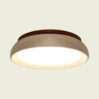 Wood frame ceiling light with travertine band on a cream background