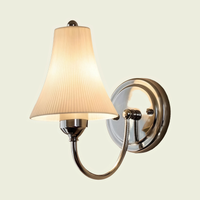 Chrome pleated ceramic wall sconce, front view