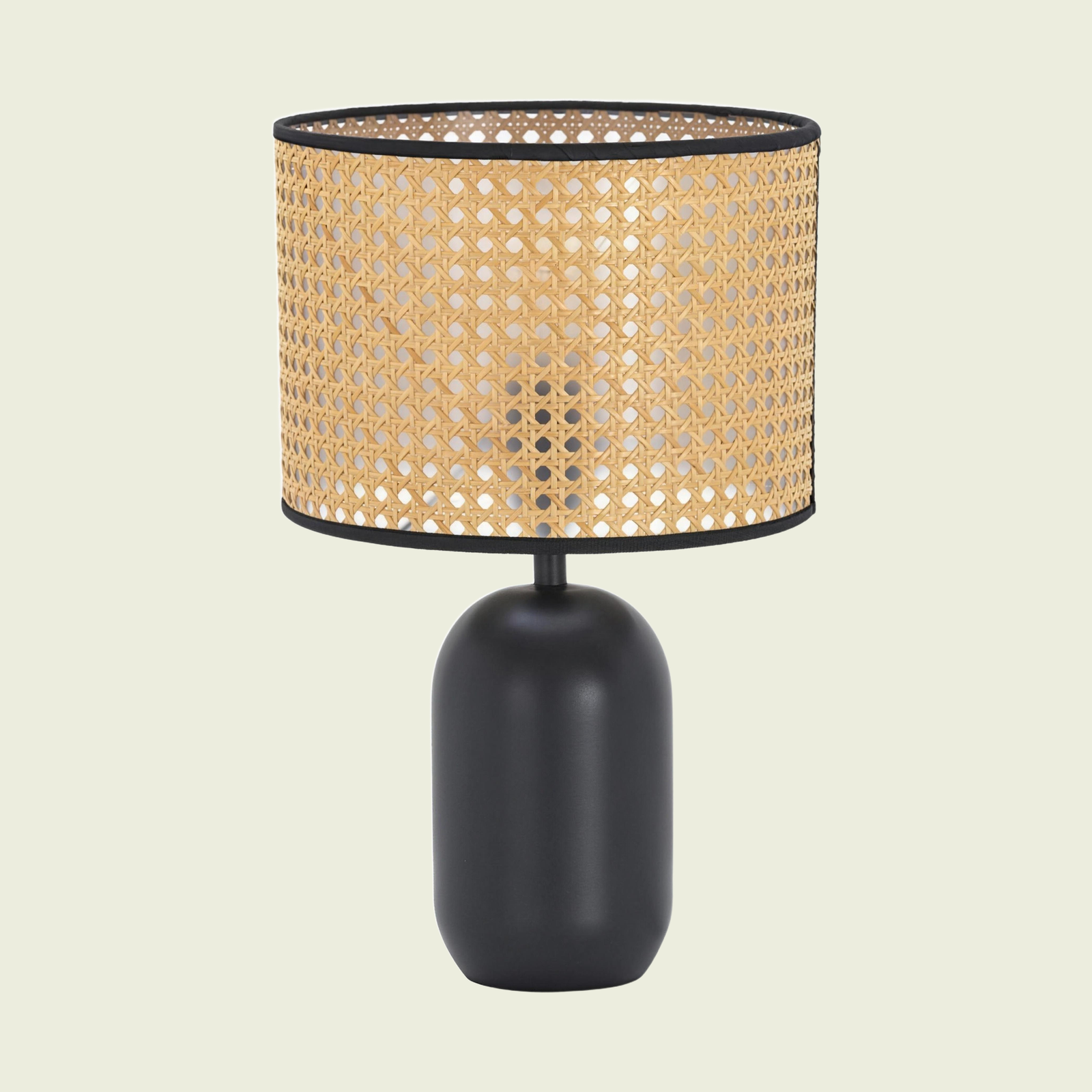 Woven Cane-Style Drum Table Lamp with matte black base, lit