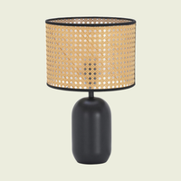Woven Cane-Style Drum Table Lamp with matte black base, lit