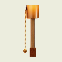 Amber dome table lamp, close-up of the brass pull chain, brass column and walnut stem