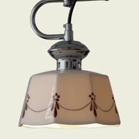 Hand-painted ceramic pendant light, close-up of the octagonal glazed shade with its painted swag, switched on