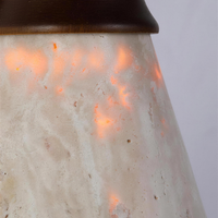Travertine wall sconce, close-up of the open-pored stone shade