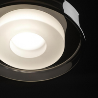 Smoke grey glass pendant light, close-up from above of the opal cylinder glowing inside the smoke-grey drum