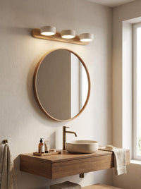 Travertine mirror sconce above a bathroom mirror, daytime