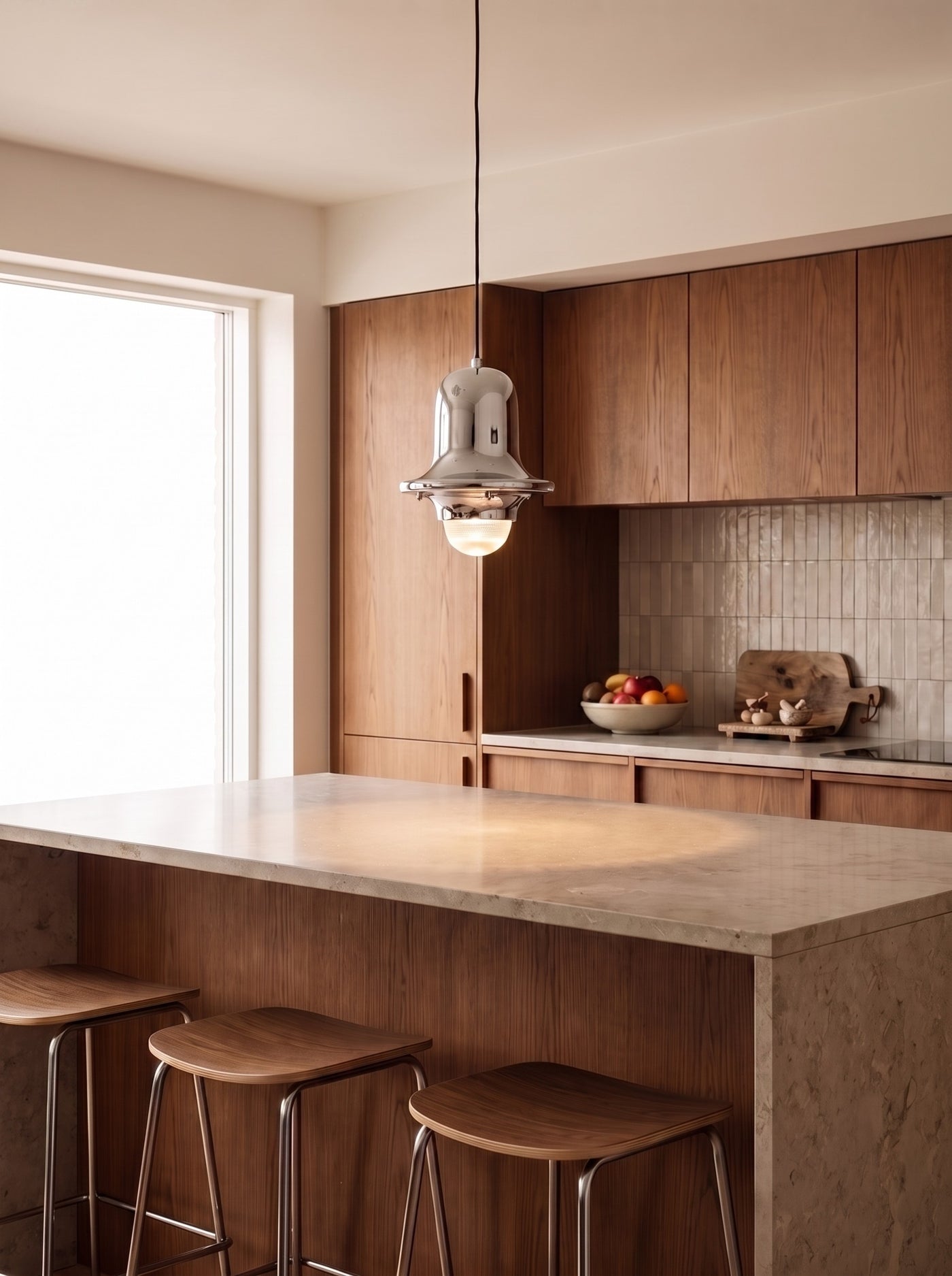 Chrome Bell Pendant Light over a kitchen island in daylight