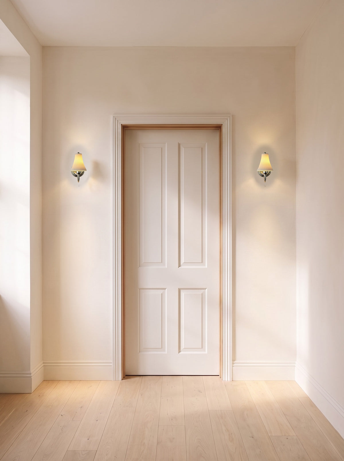 A pair of chrome pleated ceramic wall sconces flanking a door in a daylit hallway