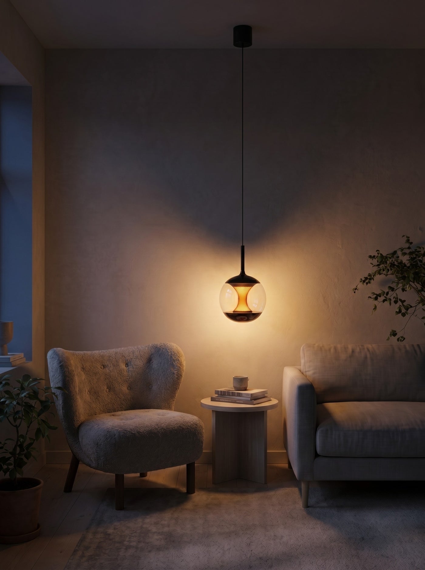 Clear glass globe pendant glowing warm at night