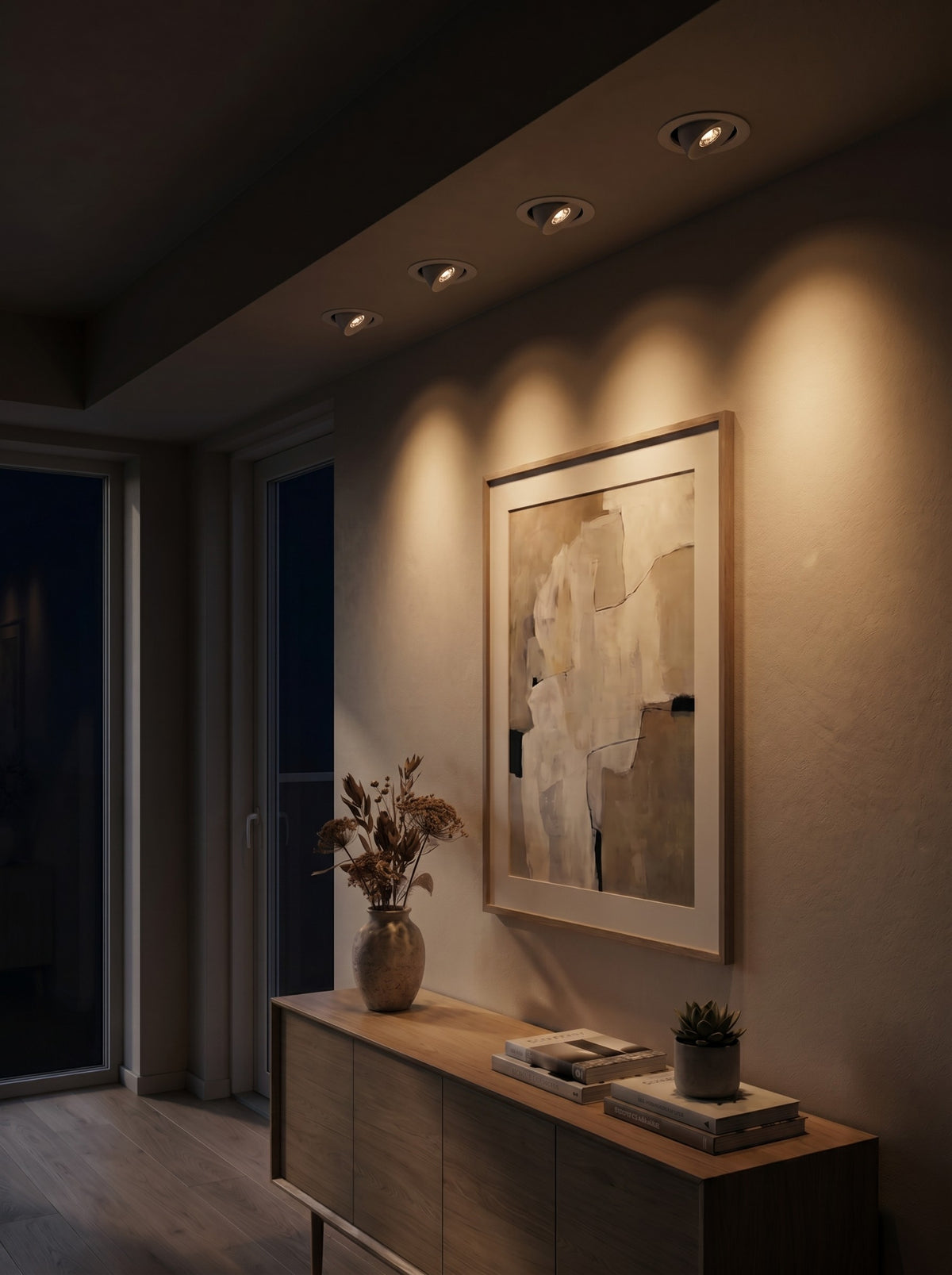 Recessed COB spotlights washing a wall and artwork at night