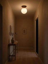 Japanese wood ceiling light glowing in a hallway at night