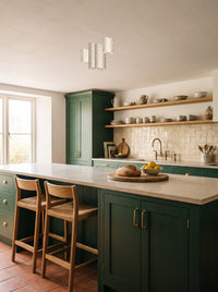 A cluster of seven travertine cylinder ceiling lights above an island in a daylit kitchen