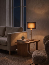 Double Shade Bedside Lamp as the only light at night beside a sofa
