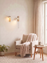 Travertine Wall Sconces lit in a daylit reading corner
