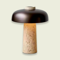 Travertine mushroom table lamp — travertine base with a dark bronze dome shade