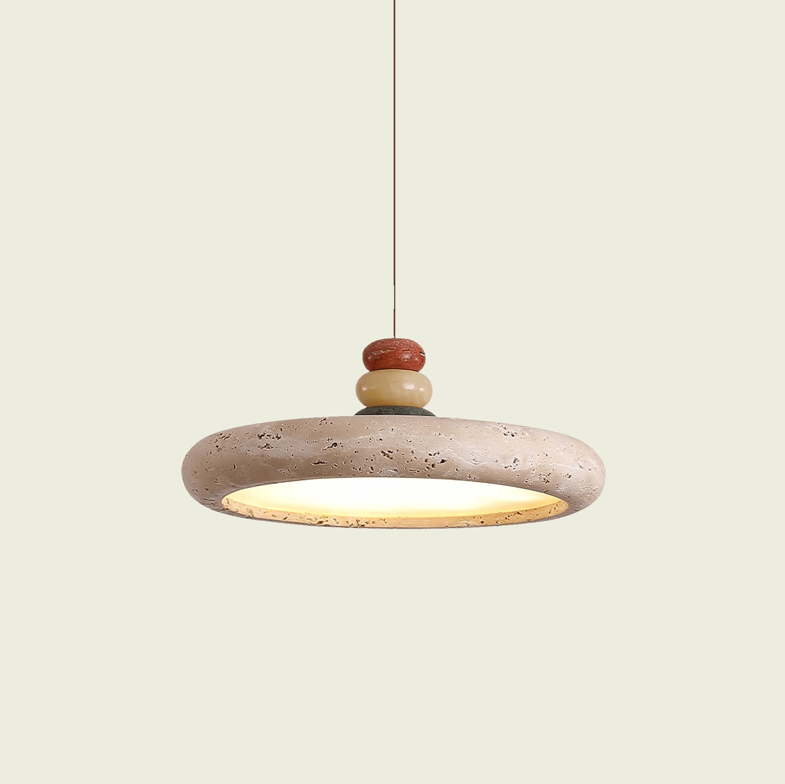 Travertine disc pendant light with stacked stone finial, on a hanging cord