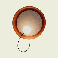 Copper fabric disc wall sconce with opal glass globe and grey felt shade, front view