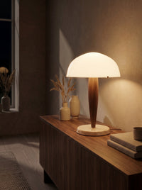 Opal glass dome table lamp glowing warm at night as the room's main light