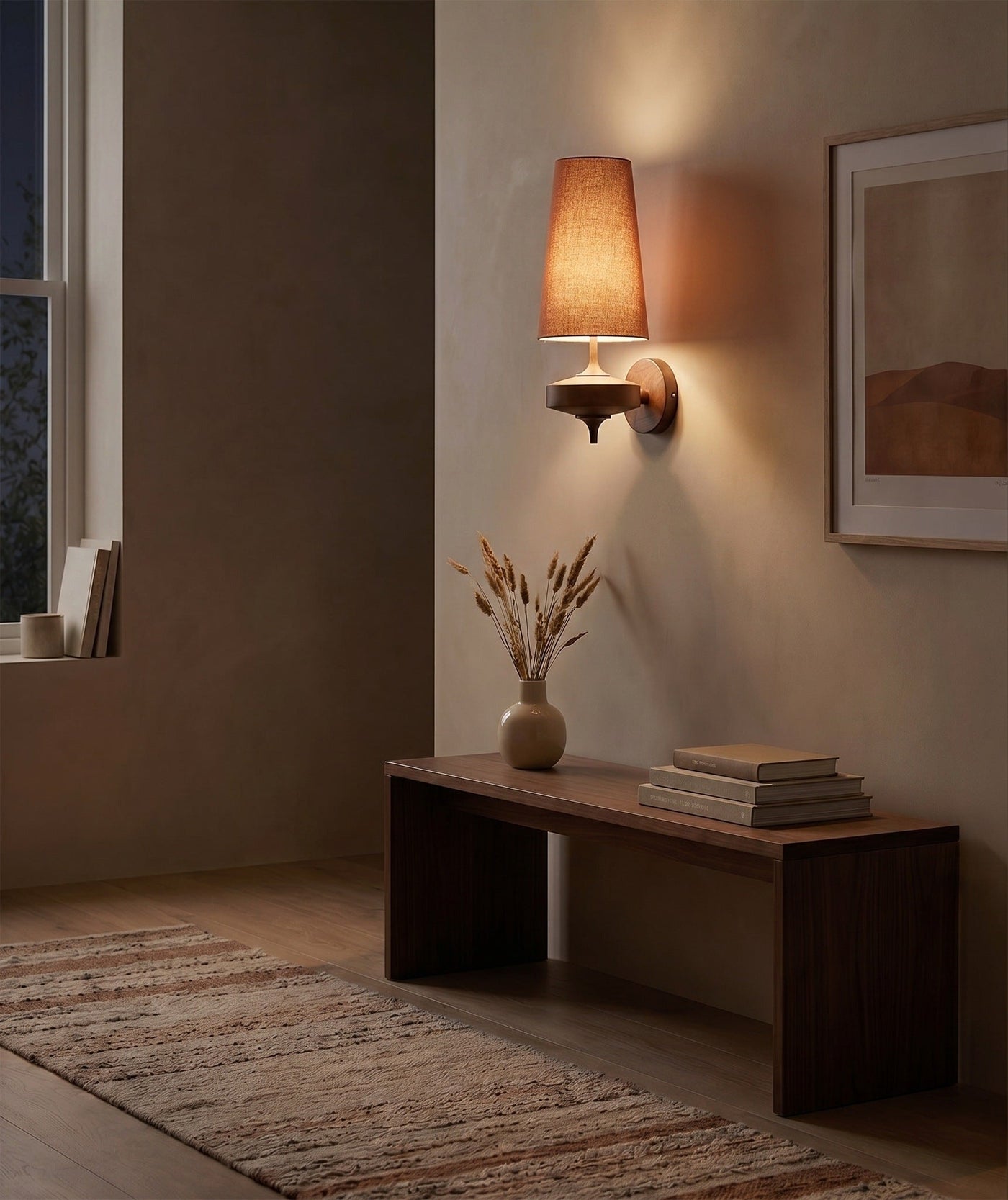 Red cloth cone wall sconce glowing warm in a dark hallway at night