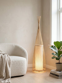 Woven bamboo floor lamp in a reading corner, daytime