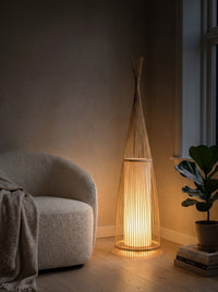 Woven bamboo floor lamp glowing warm at night