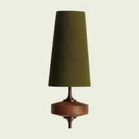 Green fabric cone wall sconce on a turned walnut mount, front view