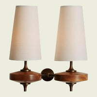 White fabric double cone wall sconce on twin walnut mounts, front view