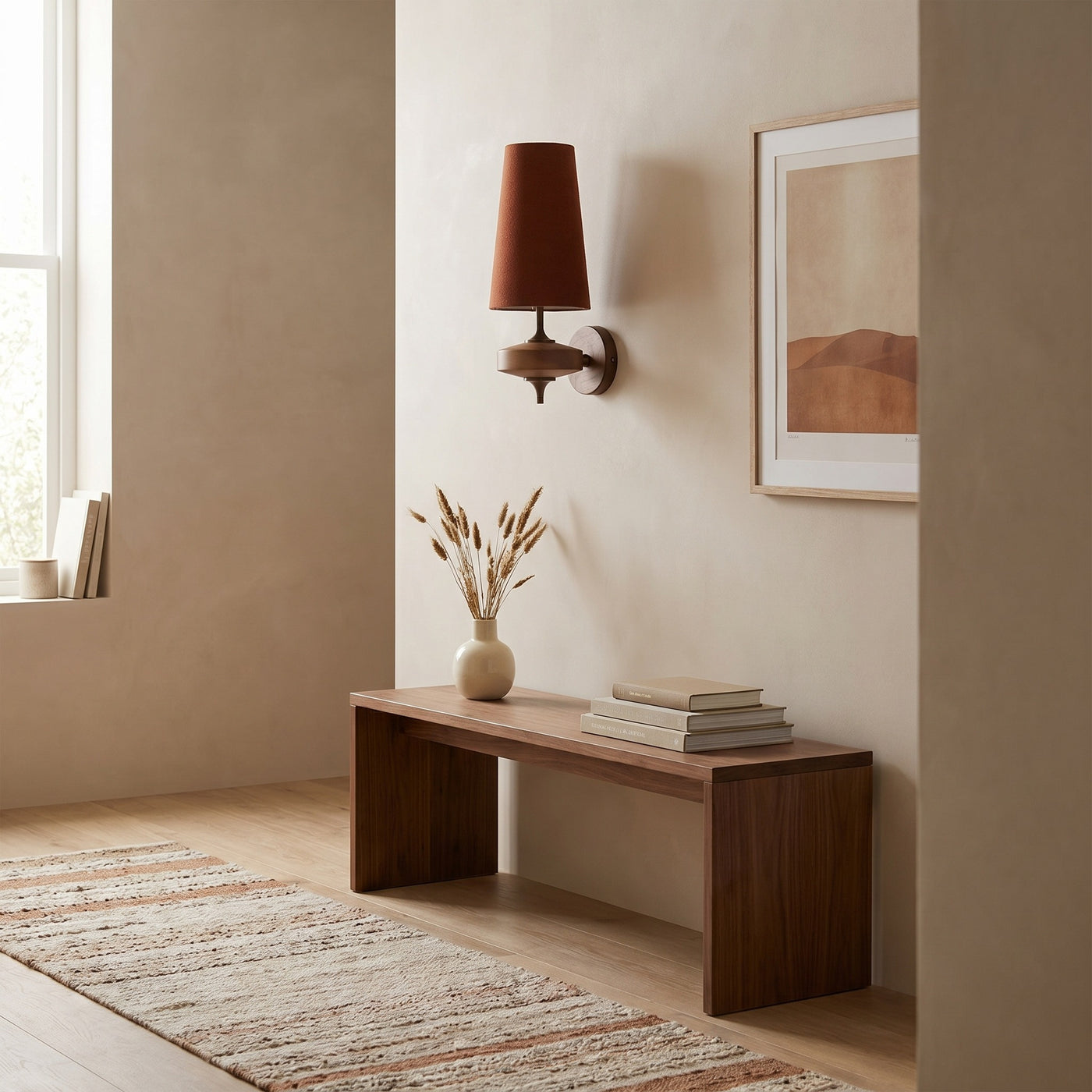 Red cloth cone wall sconce in a daylit hallway above a walnut bench