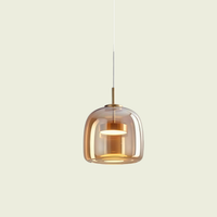 Amber glass pendant light, tall Type A shade, brass cap and warm glow