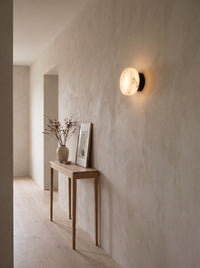 Marble dome wall sconce in a calm hallway, daytime