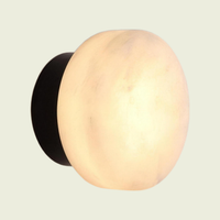 Marble dome wall sconce, cloud-stone shade on a black base, on a cream background